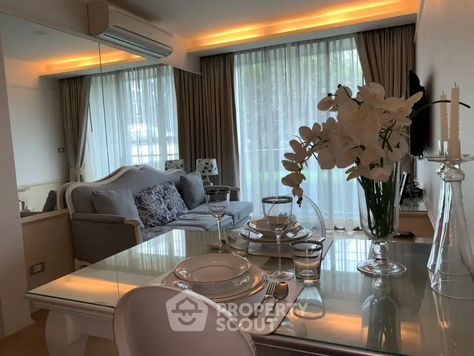 Elegant living room with modern decor, large windows, and stylish dining setup in a cozy apartment.