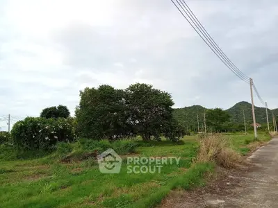 Scenic land plot with lush greenery and mountain views, ideal for development or investment.