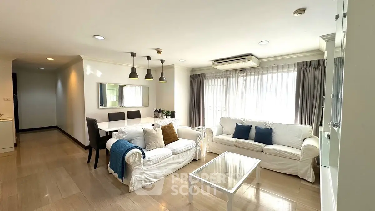 Spacious living room with elegant decor and ample natural light in modern apartment.