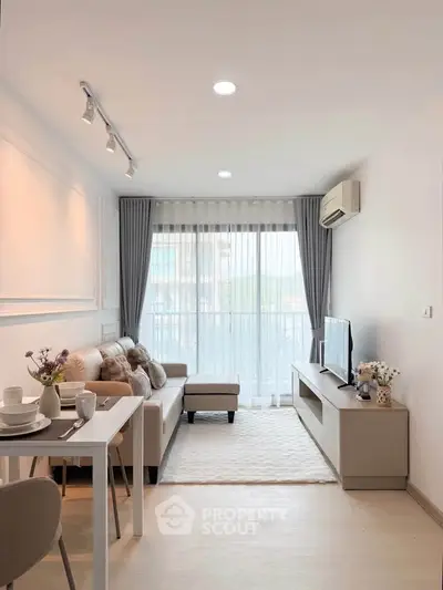 Modern living room with cozy sofa and large window, bright and inviting space.