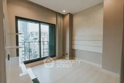 Spacious modern bedroom with large window and city view, perfect for urban living.