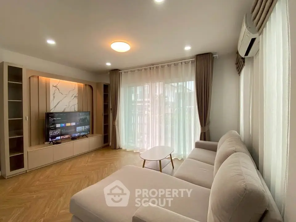 Spacious living room with modern decor, large sofa, and entertainment center, perfect for relaxation.