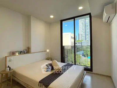 Modern bedroom with large window and city view, featuring minimalist decor and air conditioning.