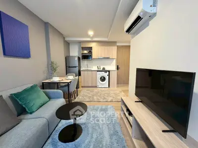 Modern living room with open kitchen, featuring sleek furniture and appliances, perfect for urban living.
