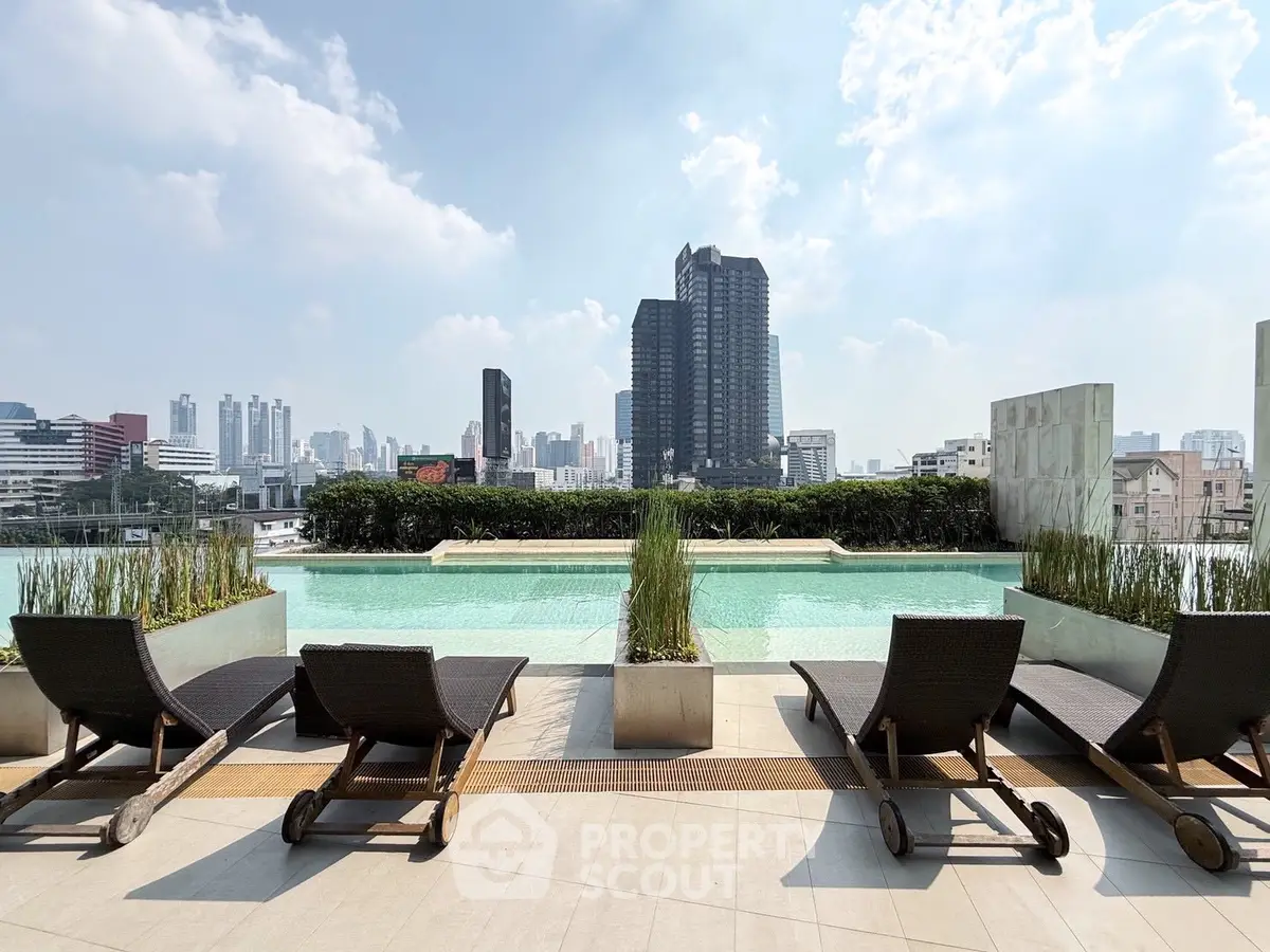 Luxurious rooftop pool with stunning city skyline view and modern lounge chairs.