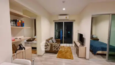 Modern living room with cozy sofa, TV, and sliding glass door to bedroom in stylish apartment.