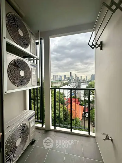 High-rise balcony with city view and air conditioning units, perfect for urban living.