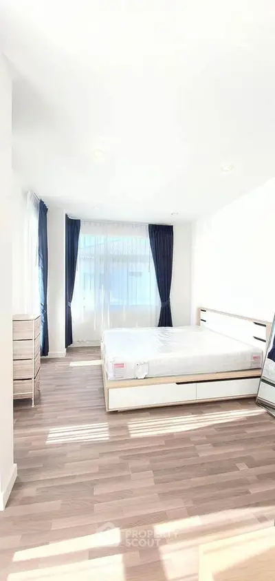 Bright and spacious bedroom with modern furnishings and large windows for natural light.