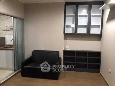 Modern living room with sleek black sofa and stylish cabinetry