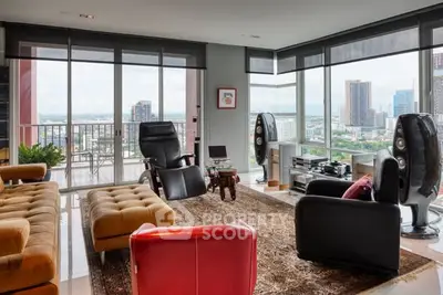 Luxurious living room with panoramic city views and modern furnishings in a high-rise apartment.