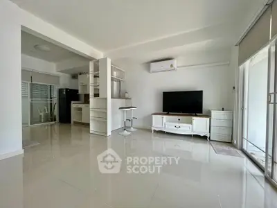 Spacious modern living room with open kitchen and sleek design