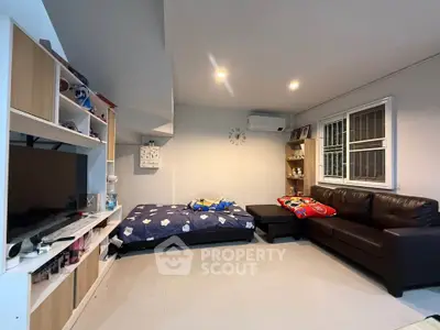 Cozy living room with modern furniture and entertainment center, perfect for relaxation.