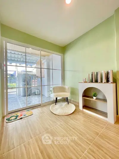 Bright room with green walls, sliding glass doors, and modern decor