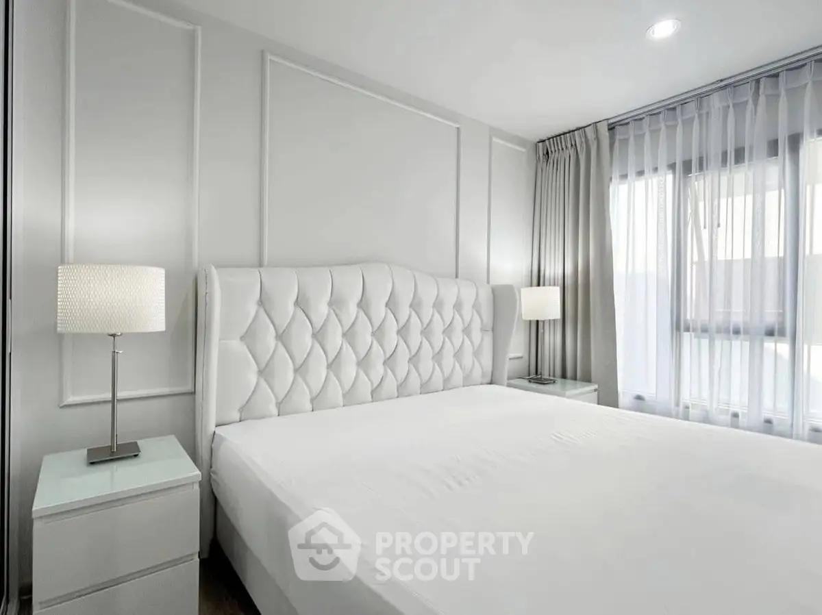 Elegant bedroom with plush headboard and natural light
