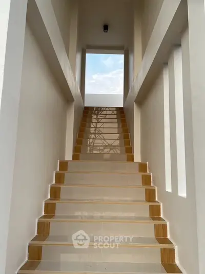Elegant staircase with modern design and natural light in a contemporary home