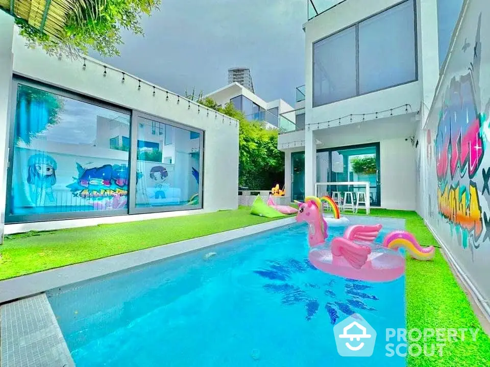 Modern villa with private pool and vibrant graffiti art, perfect for luxury living.