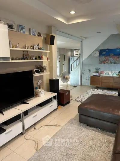 Spacious living room with modern decor and entertainment setup