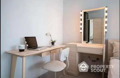 Modern study area with desk, chair, and vanity mirror in stylish apartment