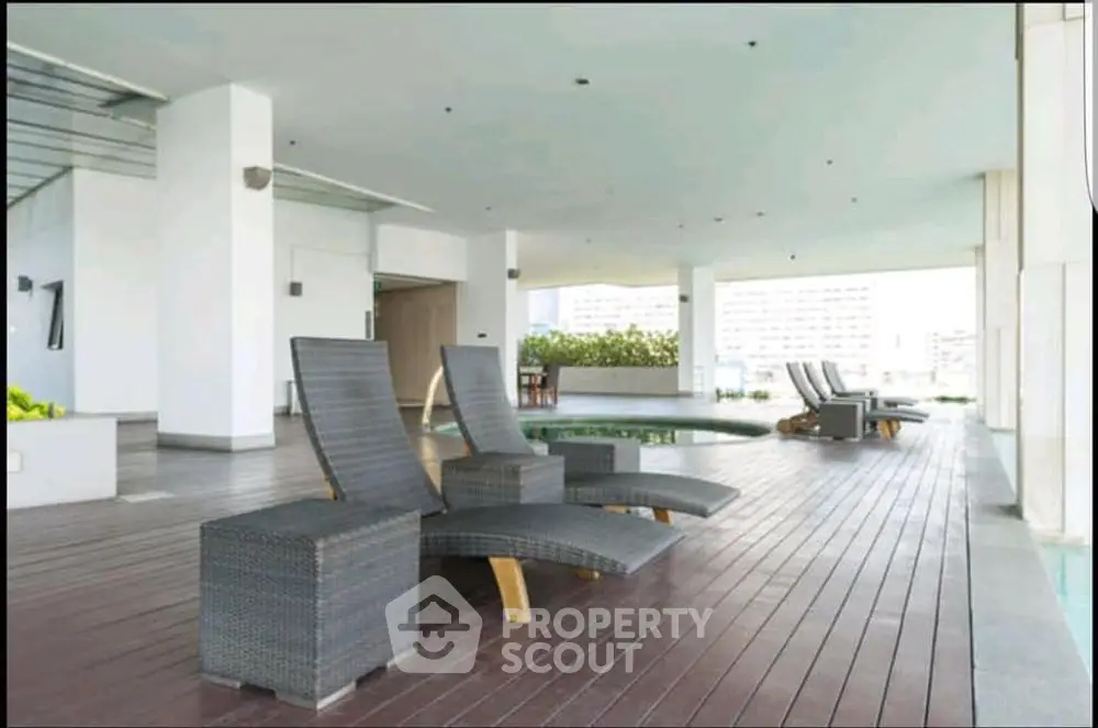 Luxurious rooftop pool area with stylish lounge chairs and city views.