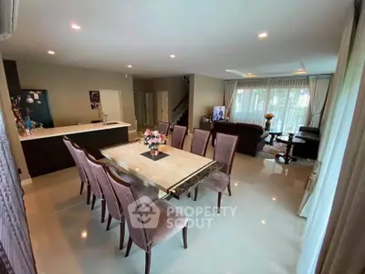 Spacious open-plan living and dining area with elegant furnishings and natural light.