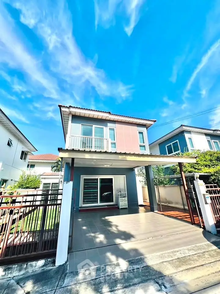 Charming two-story house with carport and lush garden in a serene neighborhood.