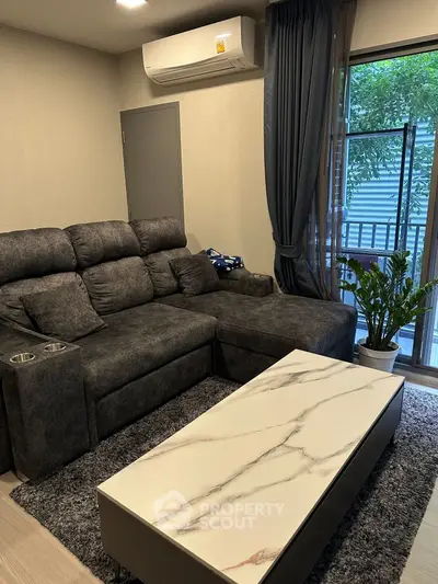 Cozy living room with plush gray sofa and modern marble coffee table