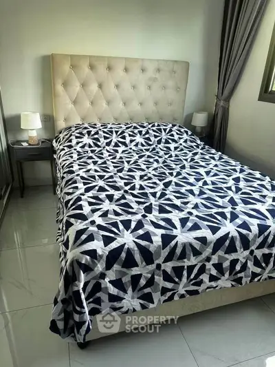Cozy bedroom with stylish bed and modern decor, perfect for relaxation.