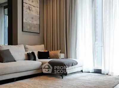 Luxurious living room with elegant sofa and floor-to-ceiling windows for natural light.