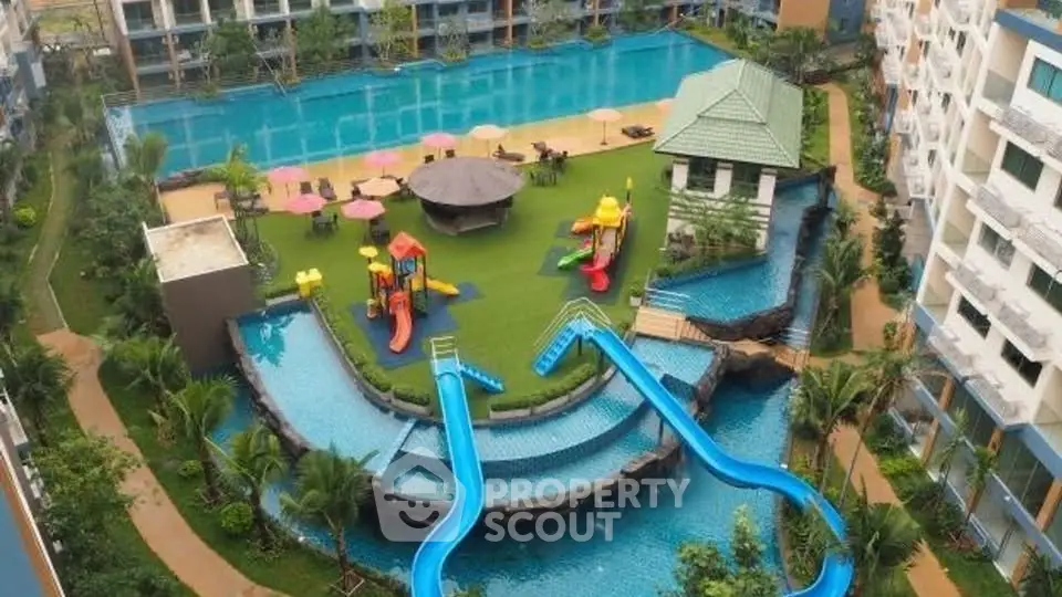 Luxurious apartment complex with large pool and water slides, perfect for family living.