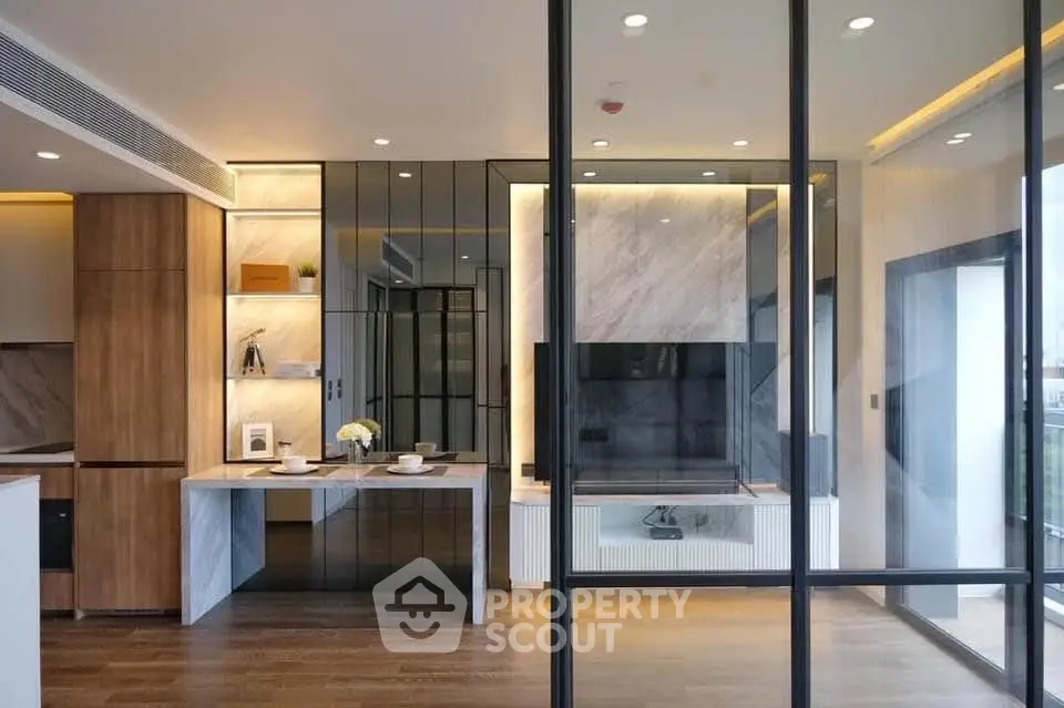 Modern living room with glass partitions and elegant wooden flooring