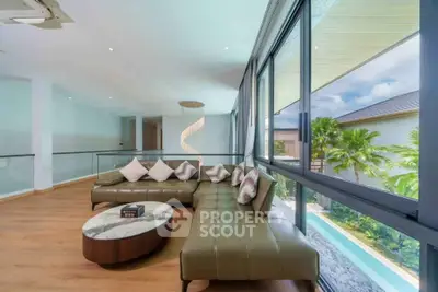 Luxurious living room with large windows and pool view, featuring modern furniture and elegant decor.
