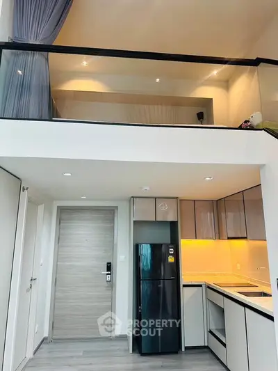 Modern loft apartment with sleek kitchen and high ceilings, featuring a stylish mezzanine and contemporary design.