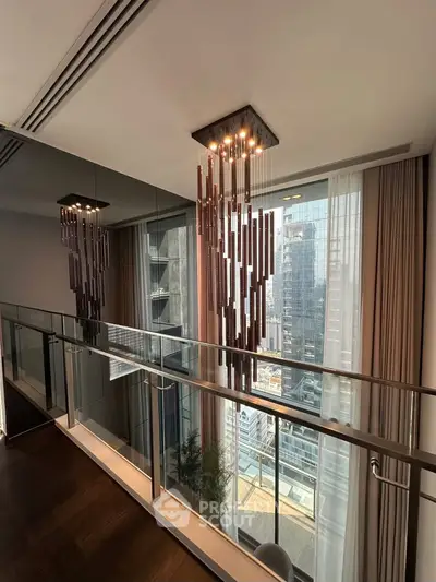 Modern interior with elegant lighting and city view from glass balcony