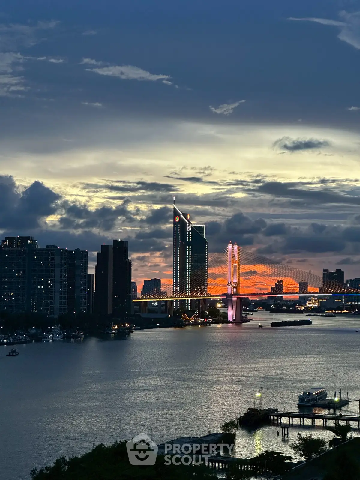 Stunning cityscape view with illuminated bridge and skyline at dusk, perfect for urban living enthusiasts.