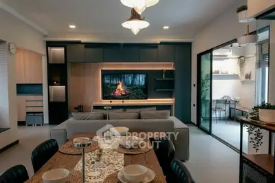 Modern living room with stylish decor and open layout, featuring a cozy dining area and elegant lighting.