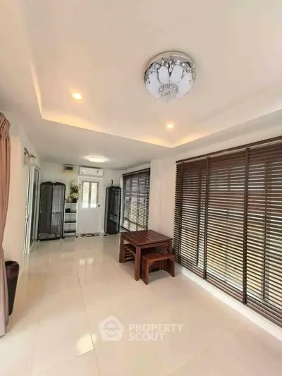 Spacious living room with elegant lighting and large windows for natural light.