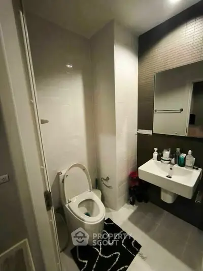 Modern bathroom with sleek fixtures and stylish decor in a contemporary apartment.