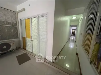 Spacious hallway with sliding doors and air conditioning unit in modern apartment