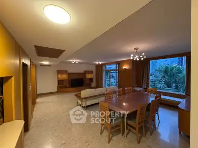 Spacious living room with dining area and large window view