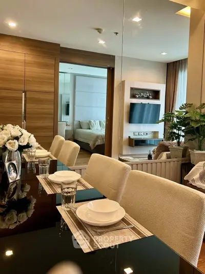 Luxurious dining area with elegant decor and view into a modern living room