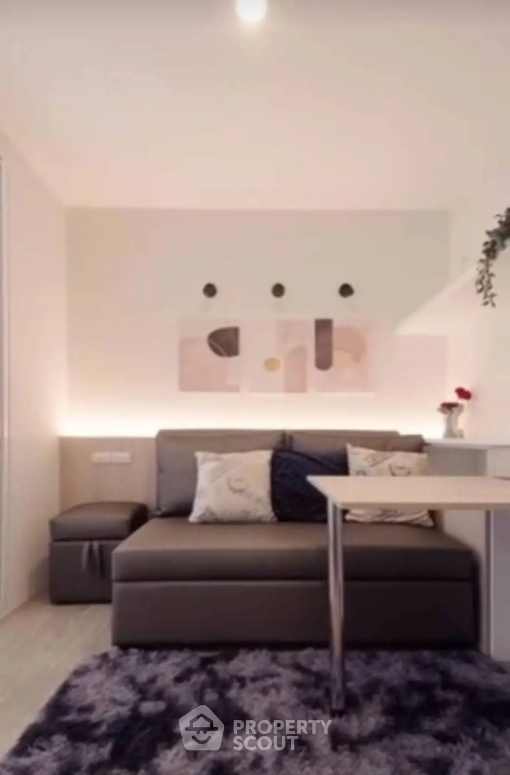 Modern living room with stylish sofa and abstract wall art