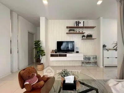 Modern living room with stylish decor and wall-mounted TV