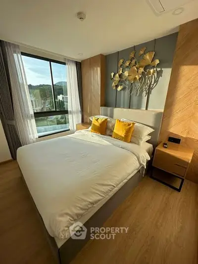 Luxurious bedroom with elegant decor and large window offering scenic views, perfect for relaxation.