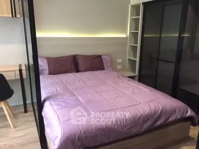 Modern bedroom with cozy purple bedding and sleek storage solutions