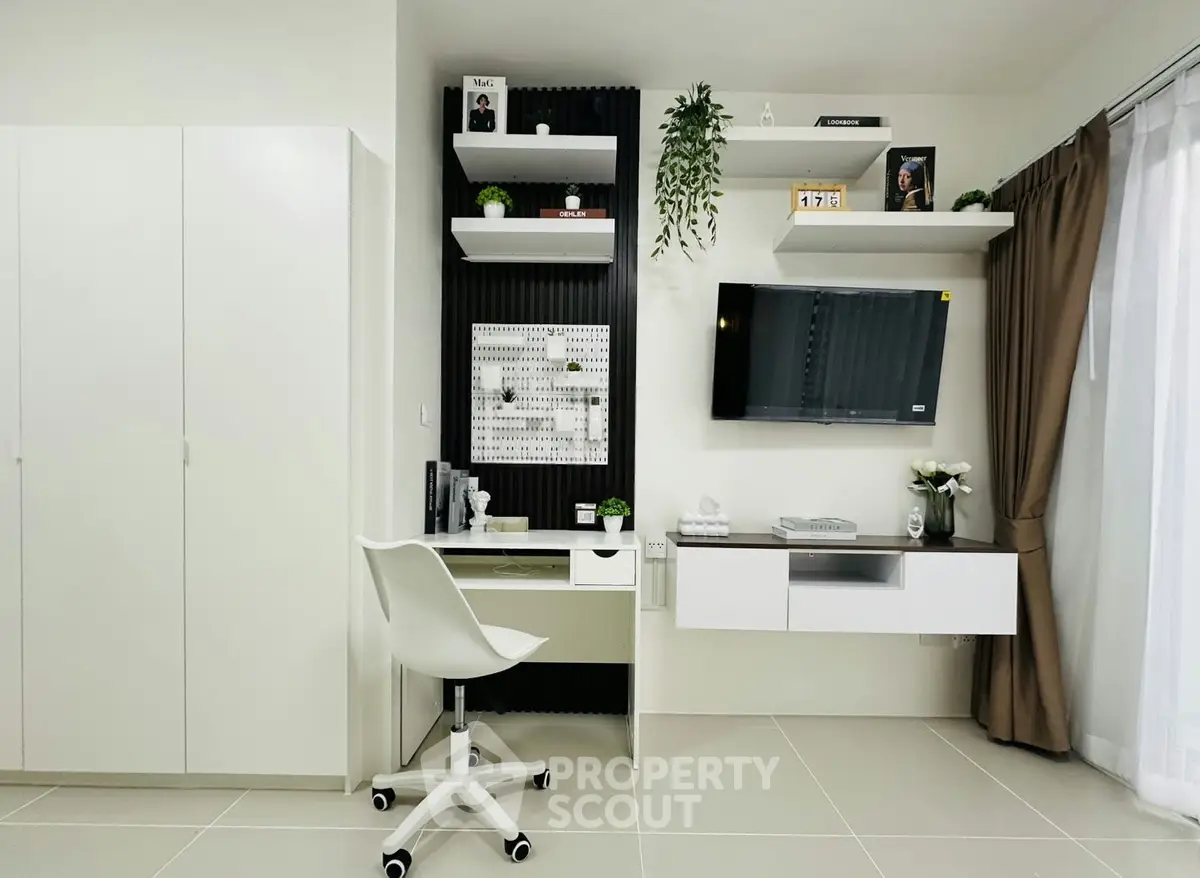 Modern study room with sleek desk, wall-mounted TV, and stylish decor