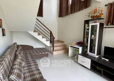 Cozy living room with modern staircase and stylish decor