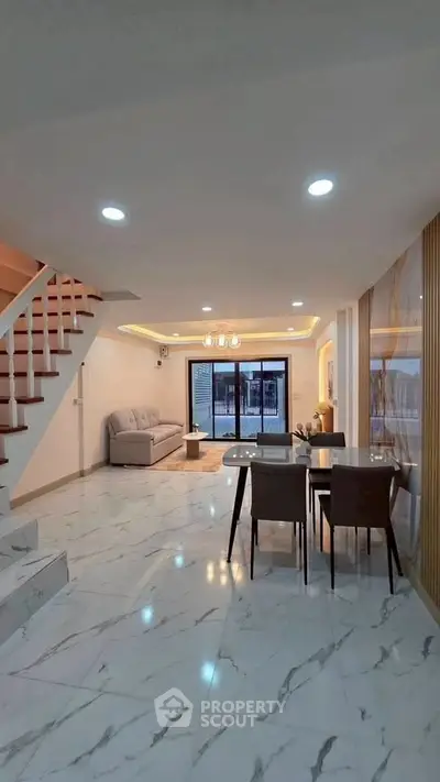 Spacious modern living room with elegant marble flooring and stylish dining area