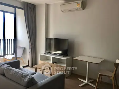 Modern living room with sleek furniture and natural light, perfect for relaxation and entertainment.