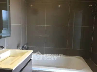 Modern bathroom with sleek design and bathtub in contemporary home.