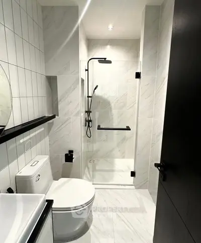 Modern bathroom with sleek shower and elegant fixtures in a contemporary real estate property.
